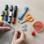 Neatly organized mini sewing tools kit with multiple compartments in the case.
