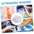 A small load of underwear being washed inside the mini washing machine with water.