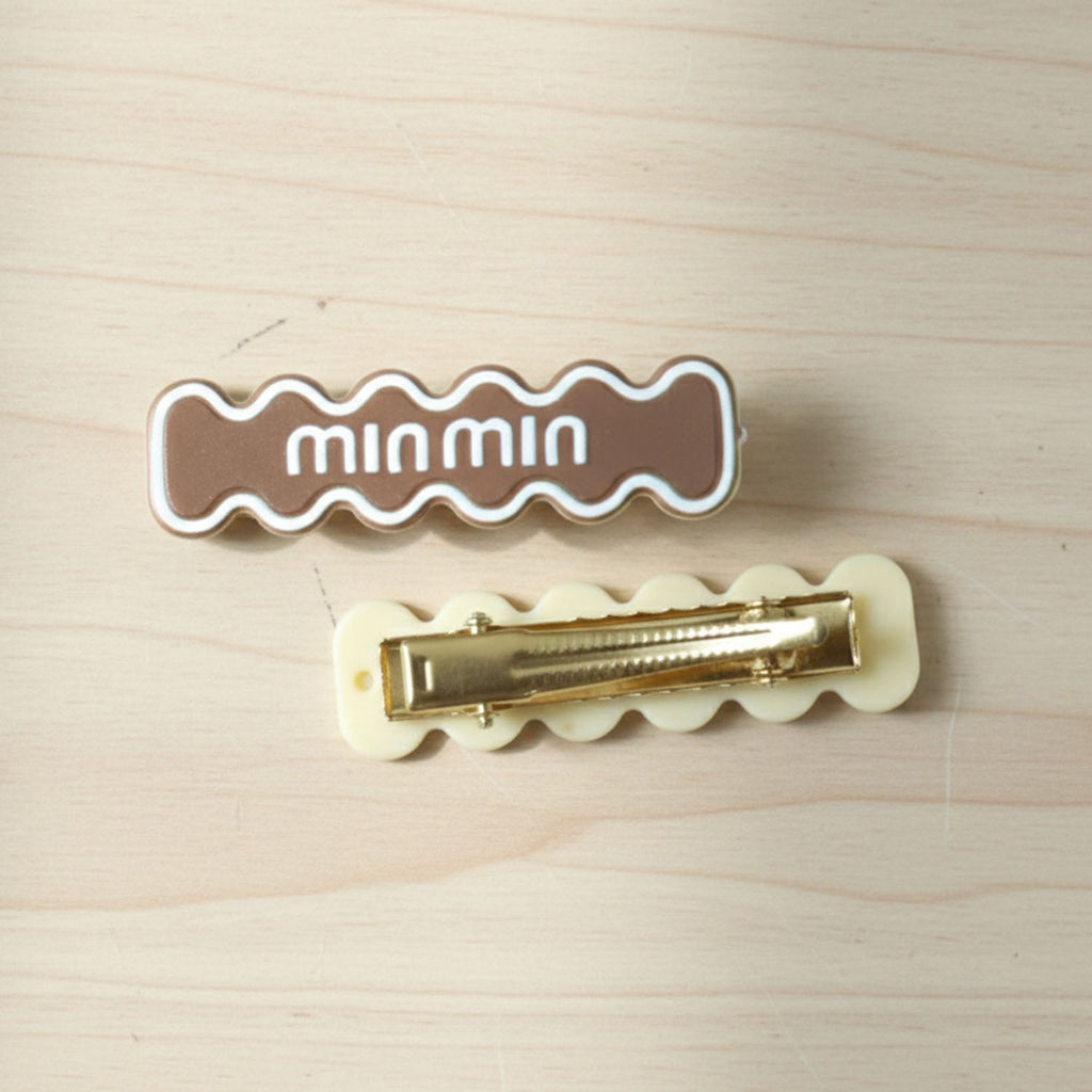Detailed close-up of secure snap mechanism on wavy hair clip