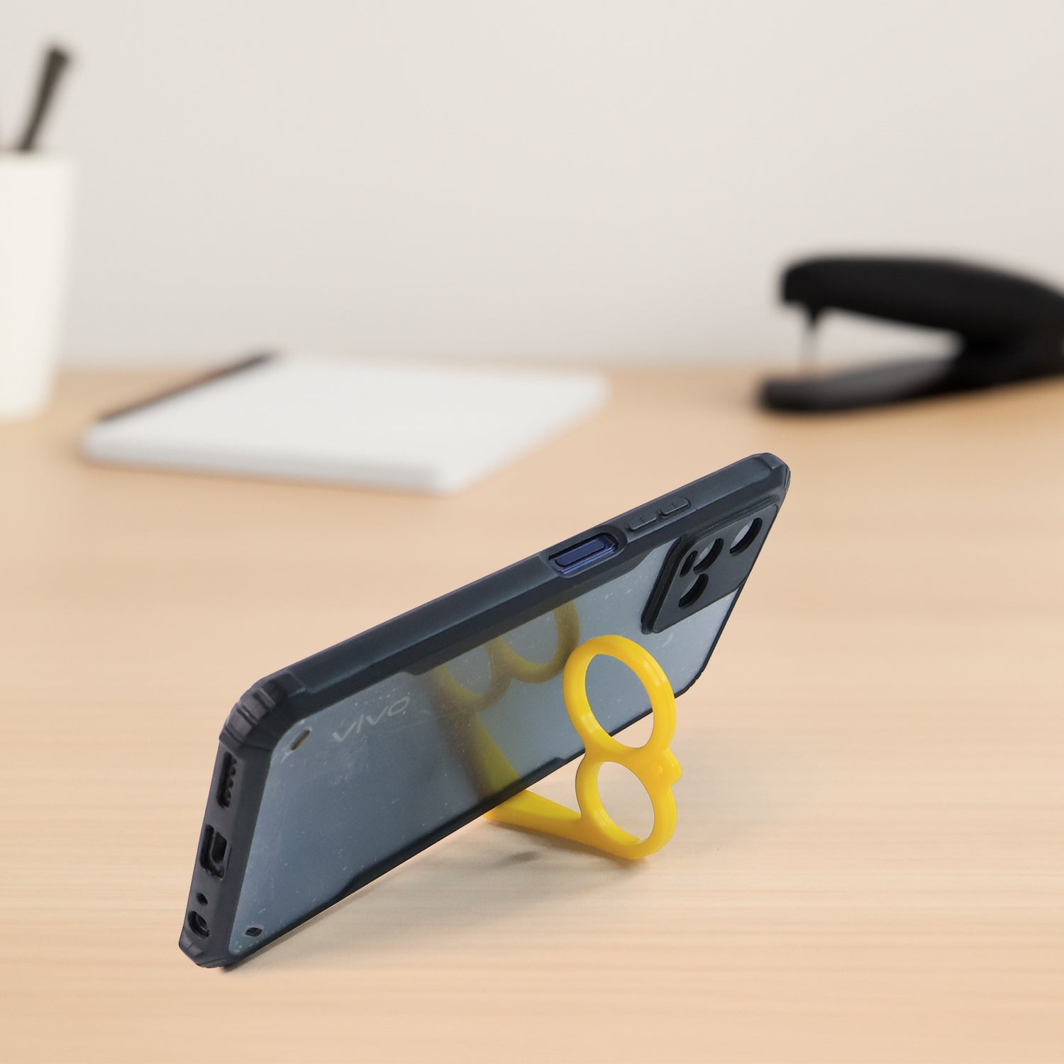 Funky hook-style hand mobile phone stand supporting smartphone upright