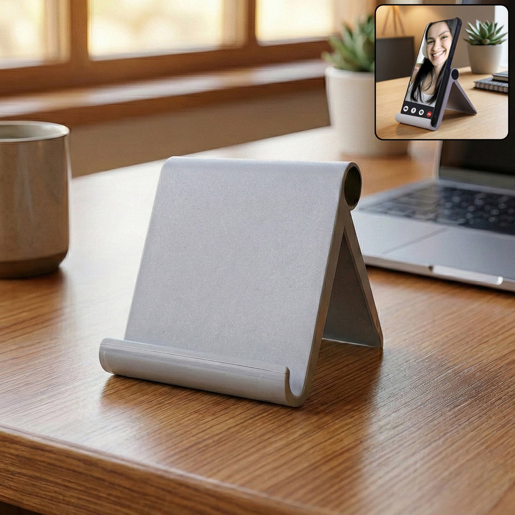 Foldable plastic mobile stand placed on a desk for hands-free phone use