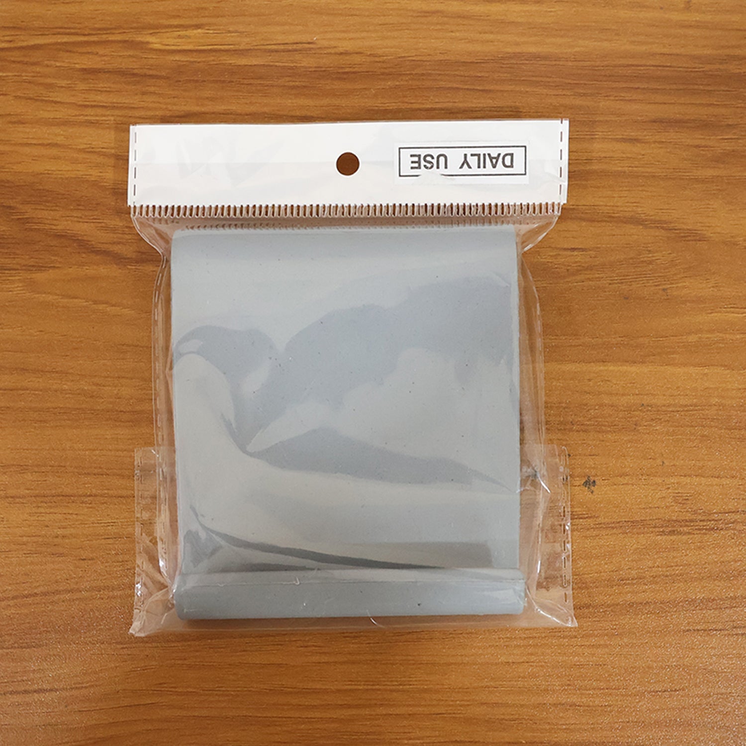 Portable foldable mobile phone stand placed on desk surface
