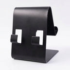 Black metal phone stand holding tablet at side view