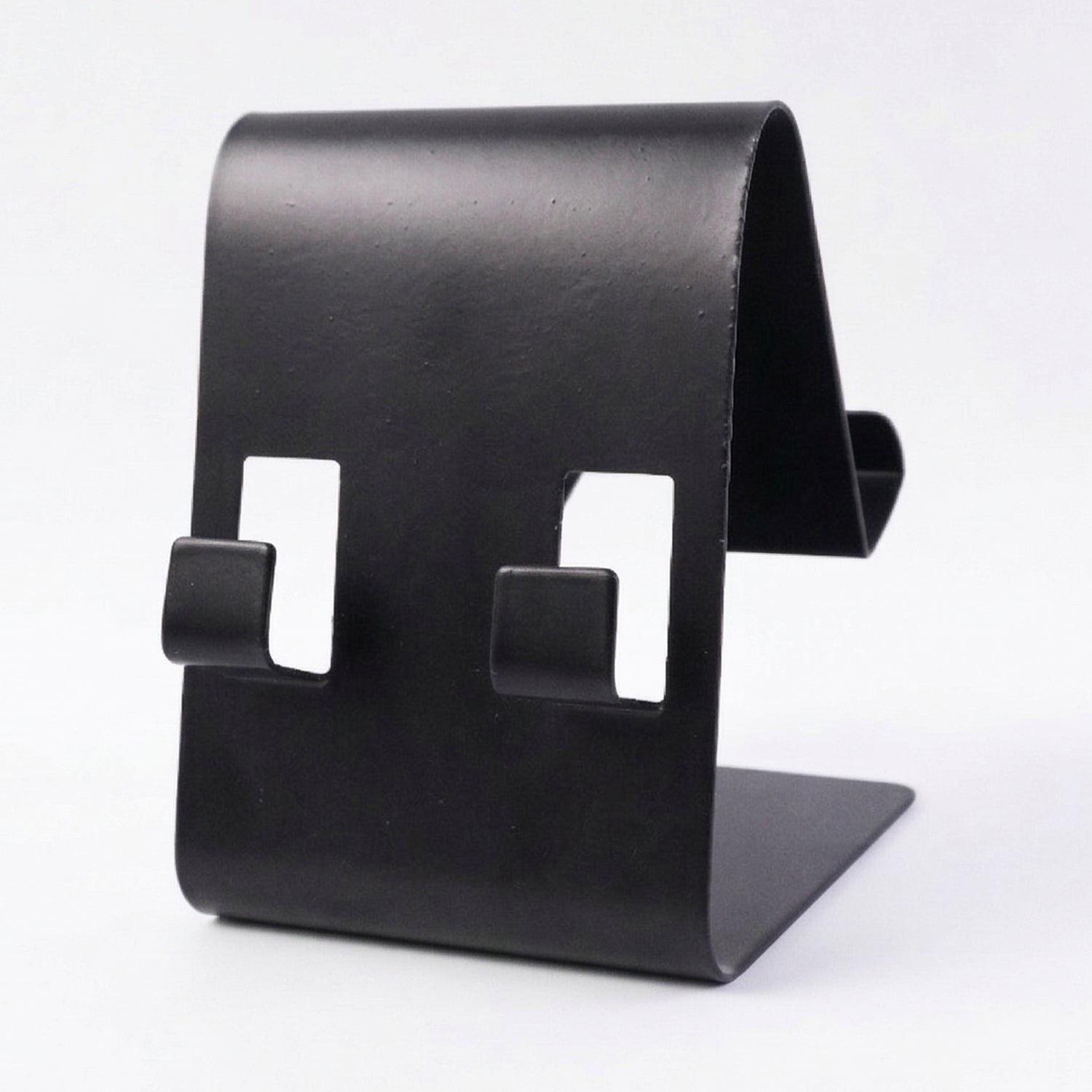 Black metal phone stand holding tablet at side view