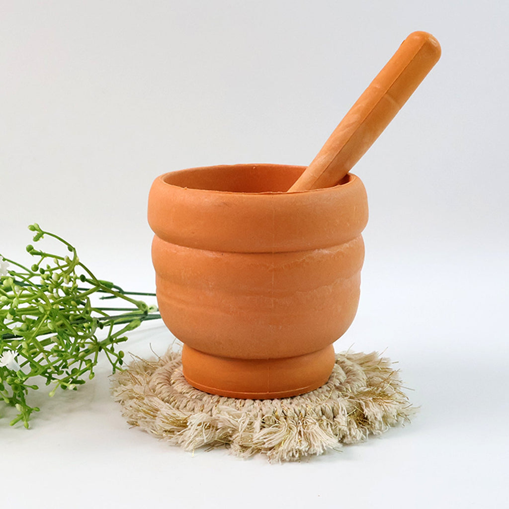 Unbreakable plastic mortar and pestle set with the ergonomic pestle resting inside the bowl.