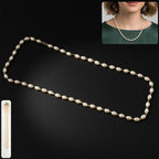 Elegant pearl necklace with gold chain accents laid flat