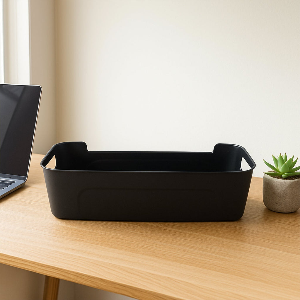 Four black plastic storage trays stacked neatly