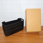 Black plastic storage baskets filled with organizing items