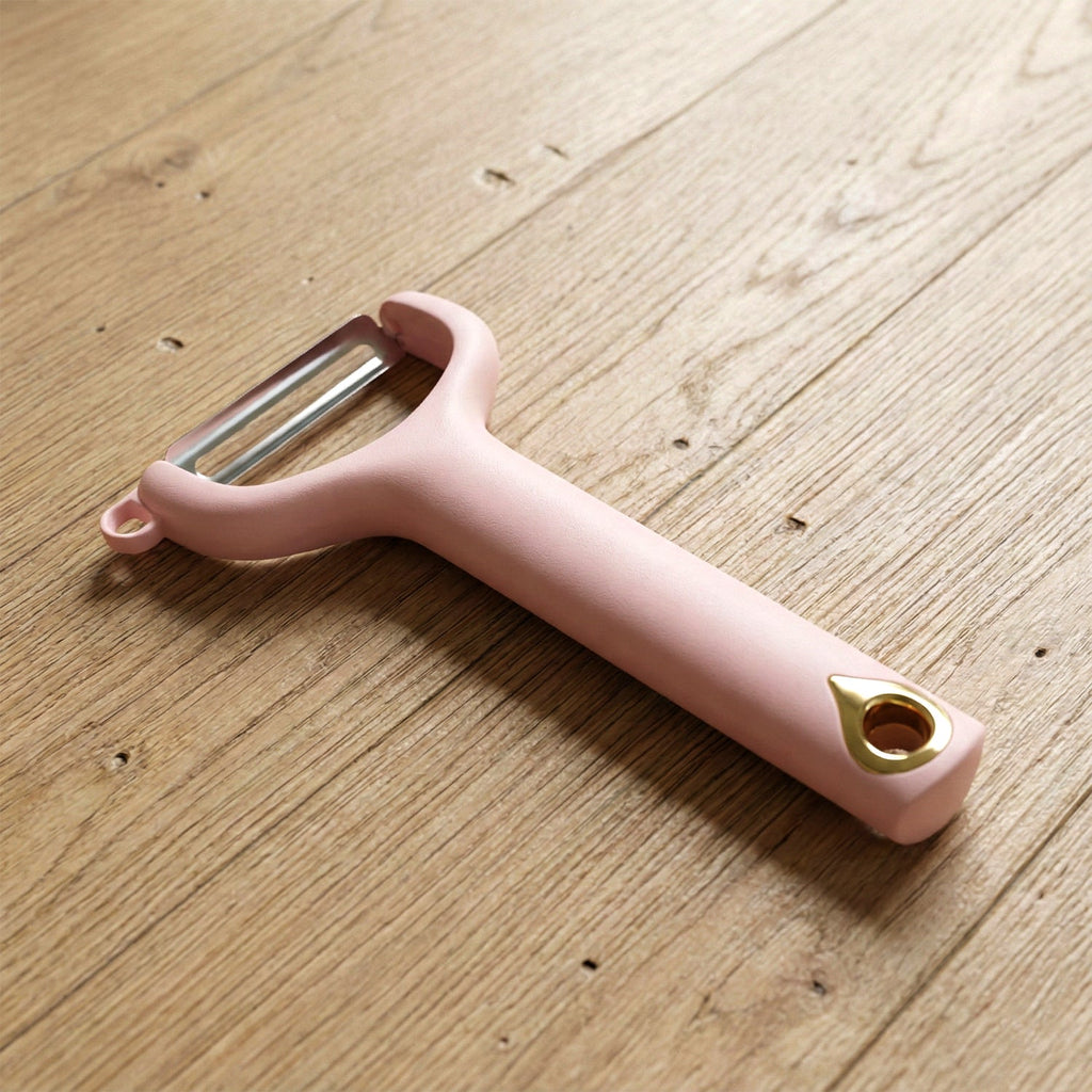 Close-up view of ergonomic handheld vegetable peeler with sharp blade