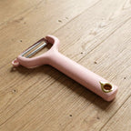Close-up view of ergonomic handheld vegetable peeler with sharp blade