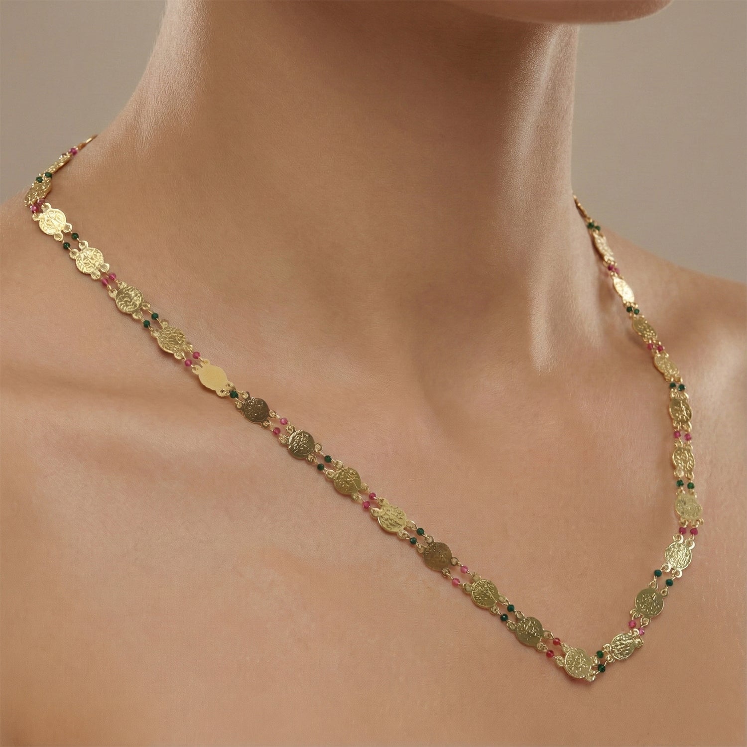 Women wearing festive gold tone coin beaded necklace