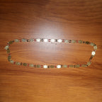 Traditional statement gold tone coin necklace worn with ethnic outfit