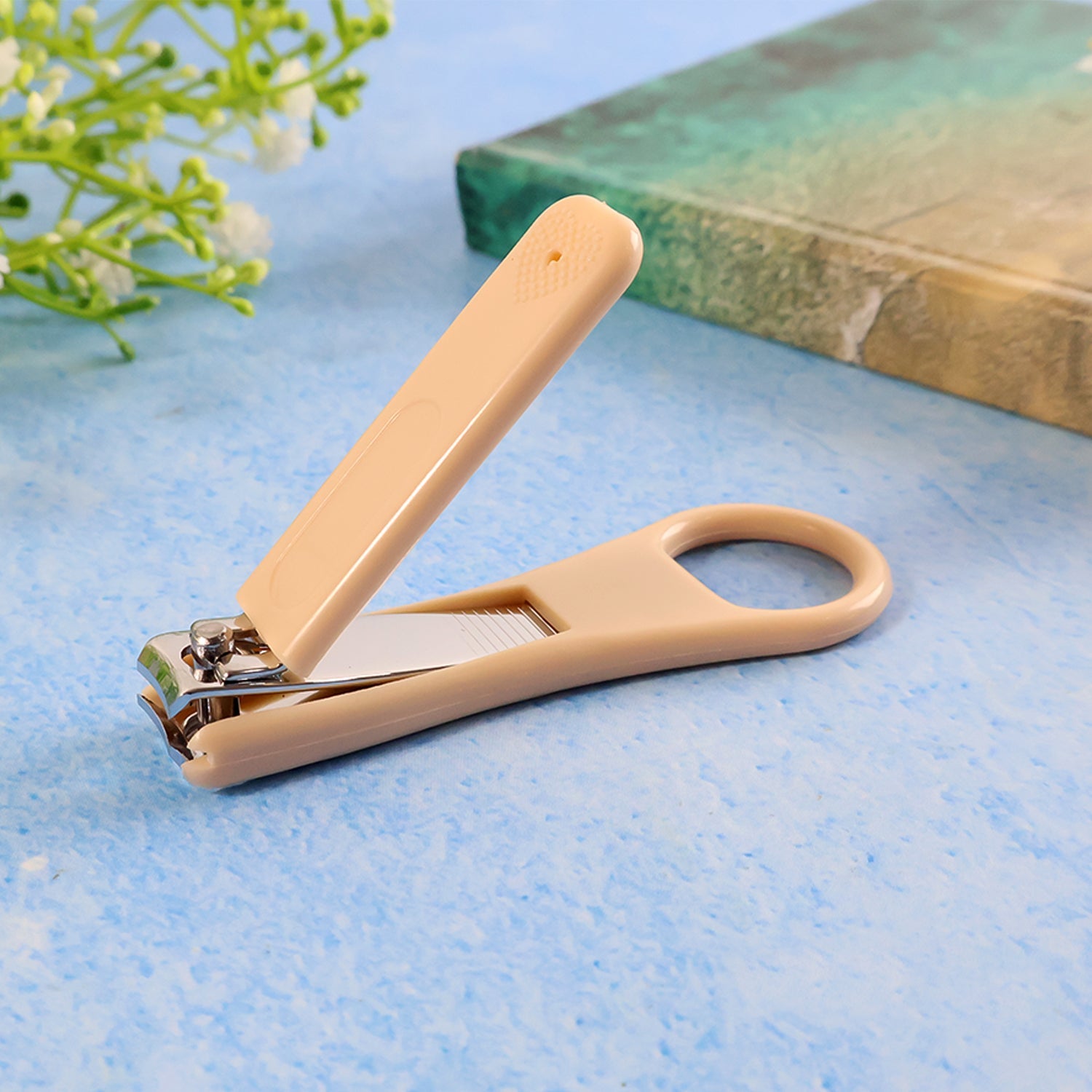 Ergonomic ring-handle nail clipper with curved blades for precise nail trimming