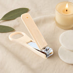 Nail clipper featuring precision curved blades and stabilizing finger loop