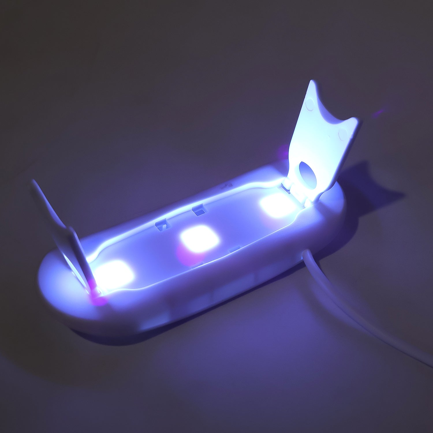 Travel-friendly UV LED nail dryer with foldable stand