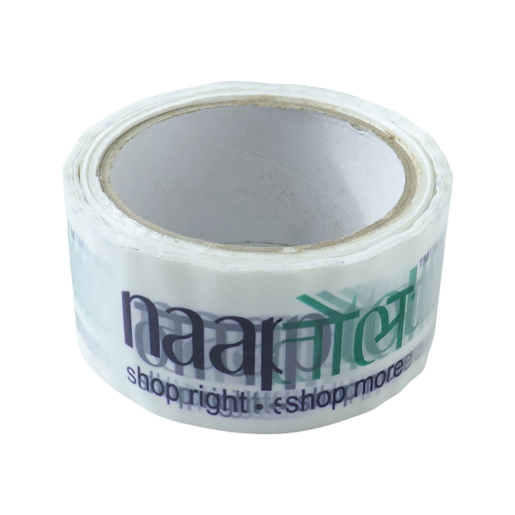 Hands applying wide printed packaging tape to seal a brown cardboard box securely.