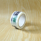 Printed packaging tape roll displayed at an angle, highlighting its strong adhesive quality.