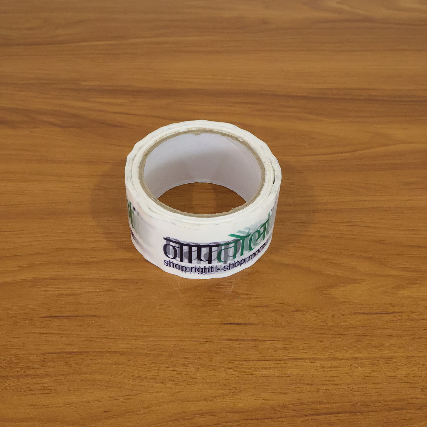 Applying printed packaging tape to seal a package, demonstrating its practicality for courier use.