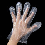 Detailed shot of the label on a pack of Grow Wear transparent disposable clear gloves.