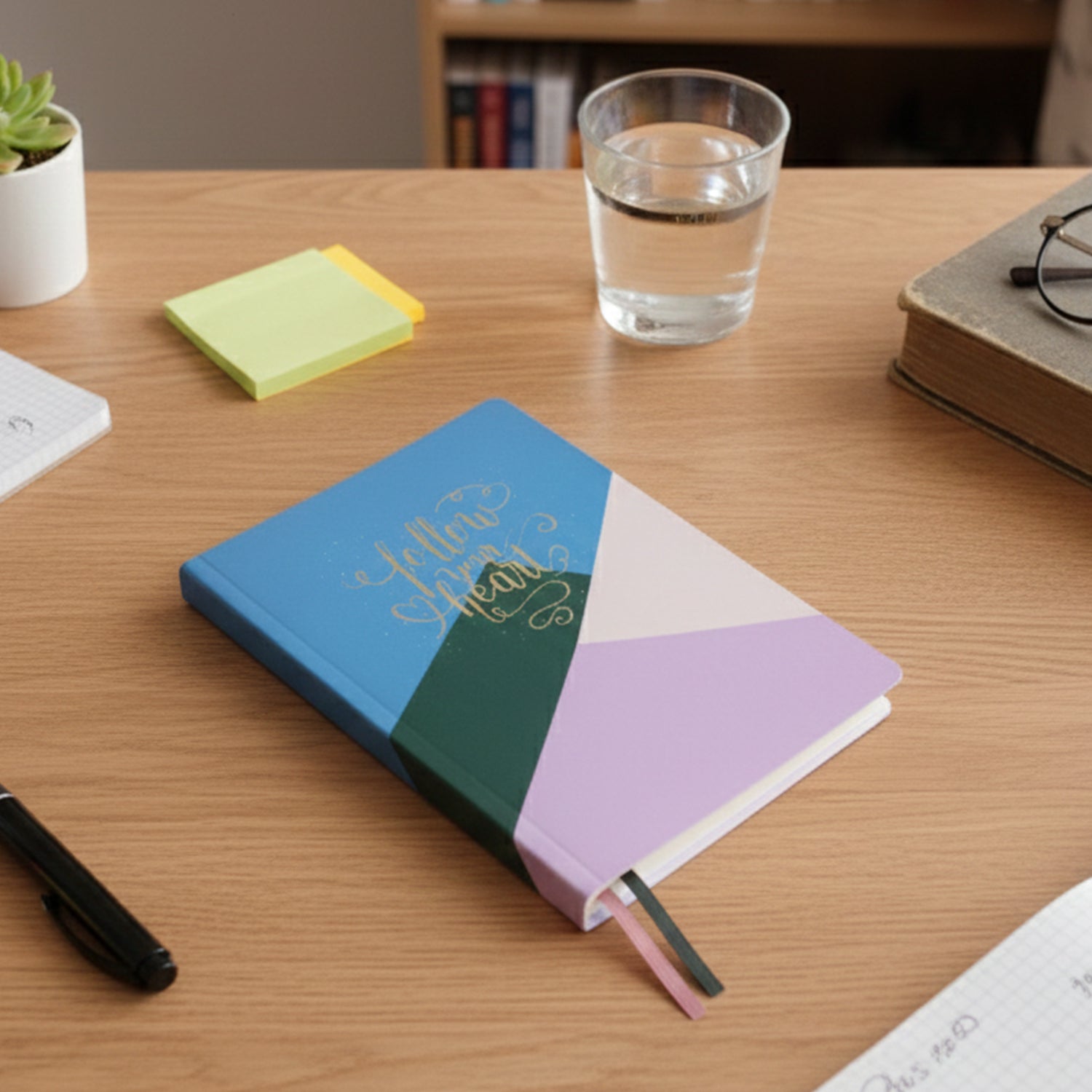 Multiple hardcover ruled notebooks stacked showing compact 21x15 cm size