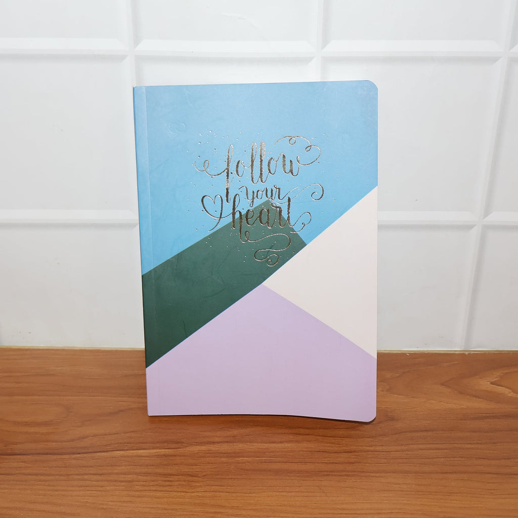 Hardcover ruled notebook used on desk for writing and planning