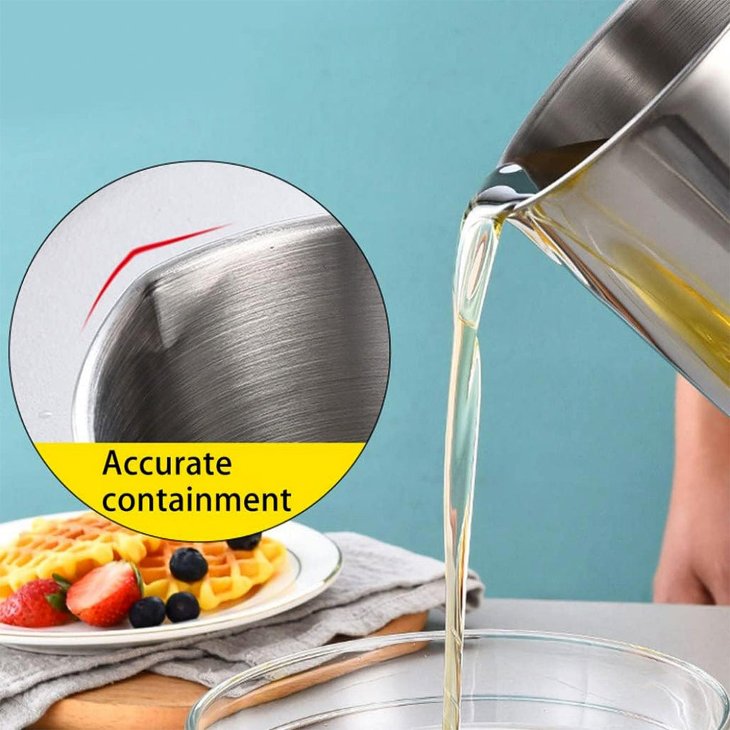 Pouring strained oil from stainless steel oil strainer pot
