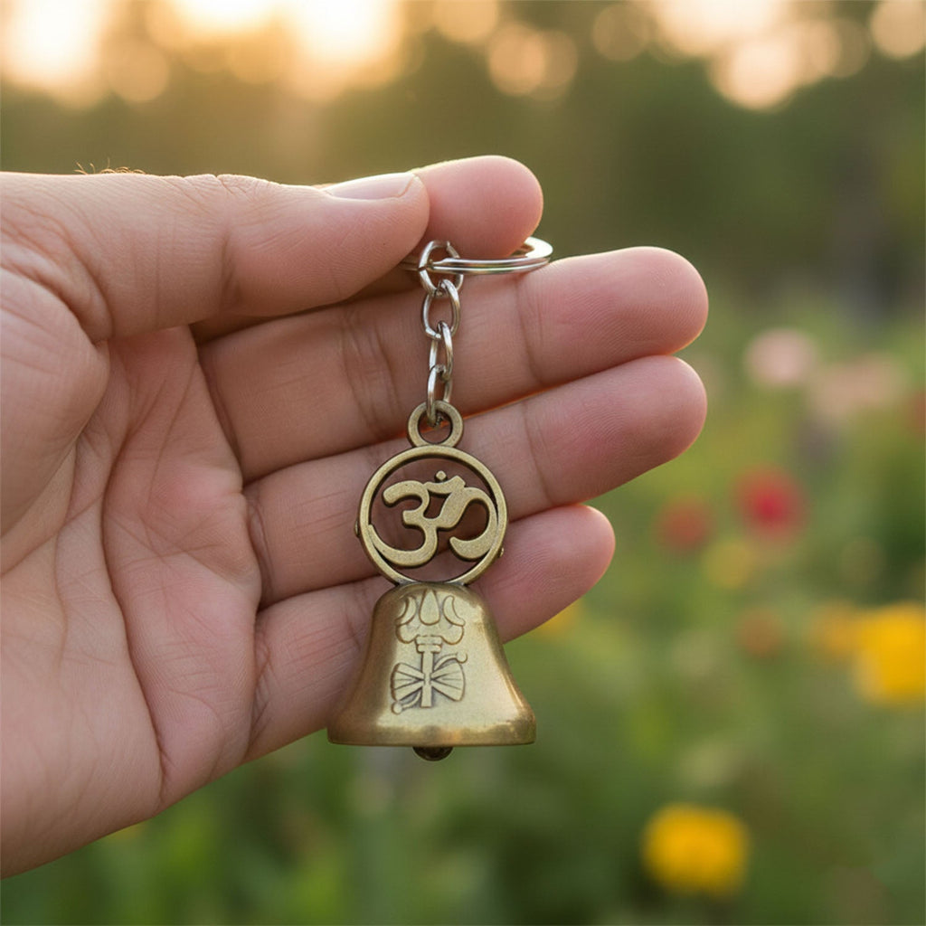 Close-up view of Om symbol on the temple bell metal keychain