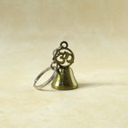 Om temple bell keychain used as decorative bag charm accessory