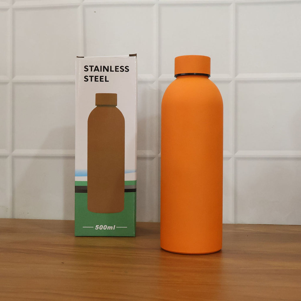 Lifestyle image featuring stainless steel insulated orange water bottle