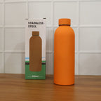 Lifestyle image featuring stainless steel insulated orange water bottle