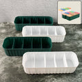 Four 5-compartment drawer organizers neatly stacked, storing socks and underwear.