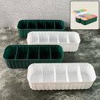 Four 5-compartment drawer organizers neatly stacked, storing socks and underwear.