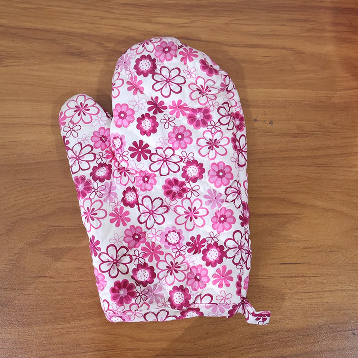 Stacked cotton oven mitt and pot holder, highlighting their soft texture.