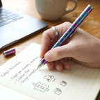 Hand demonstrating the fidget spinner function of the magnetic metal pen.