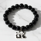Black beaded stretch bracelet with an adorable panda charm on white background.