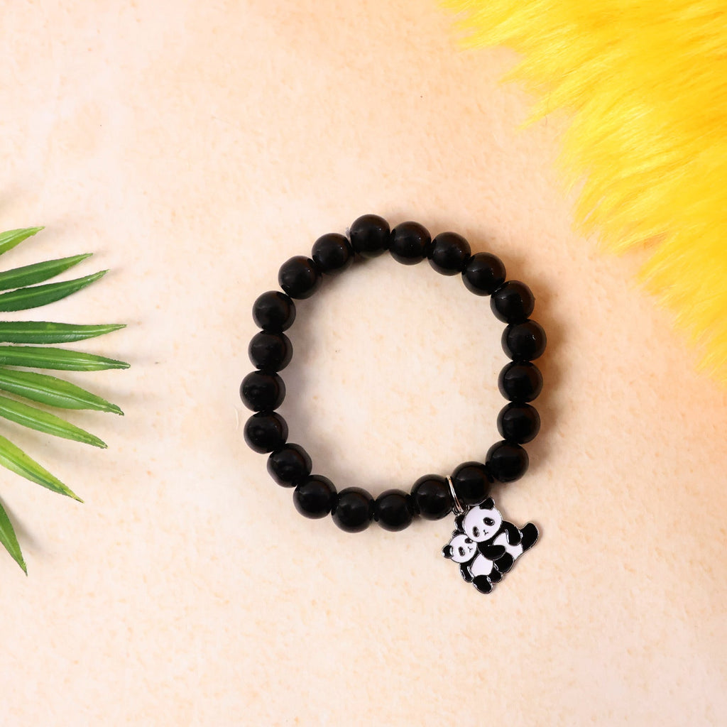 Black beaded bracelet featuring a panda charm worn on wrist.
