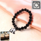 Close-up view of black beaded bracelet showcasing detailed panda charm.