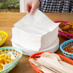 Soft absorbent tissue napkins in neat square folds for hygiene.