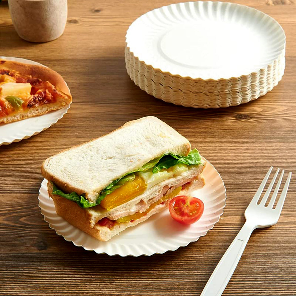 Stack of sturdy compostable paper plates for takeaway