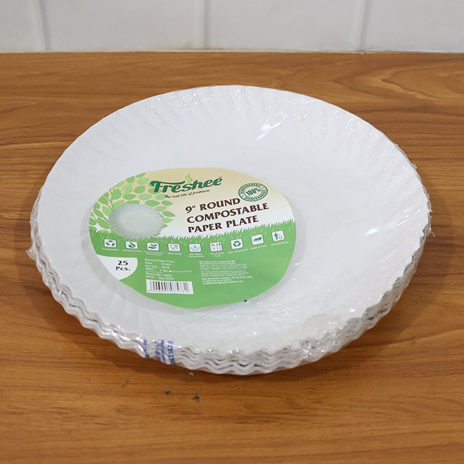 Compostable 9 inch paper plates in stack, eco-friendly