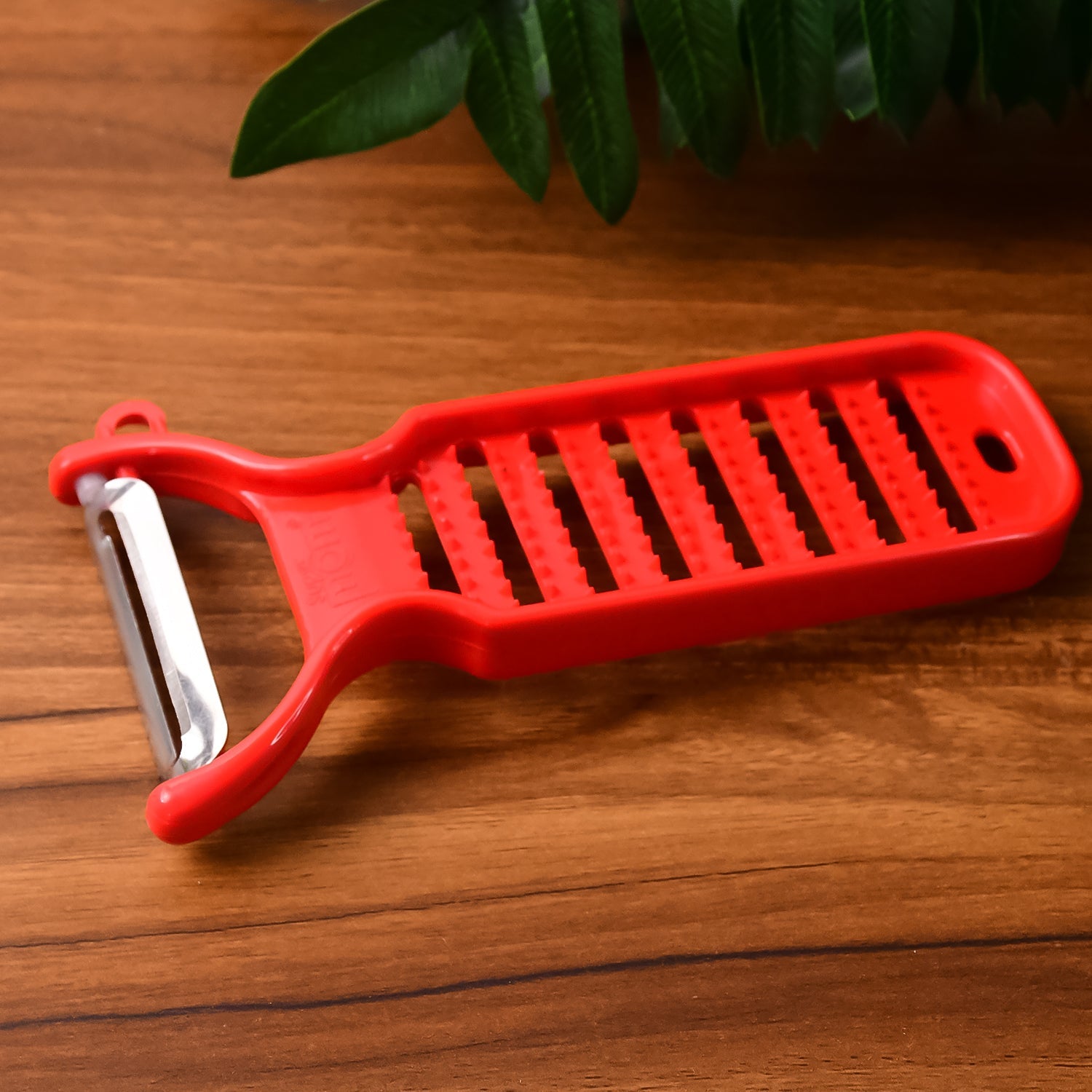 Dual-function grater and peeler tool by Supermom for fresh ginger