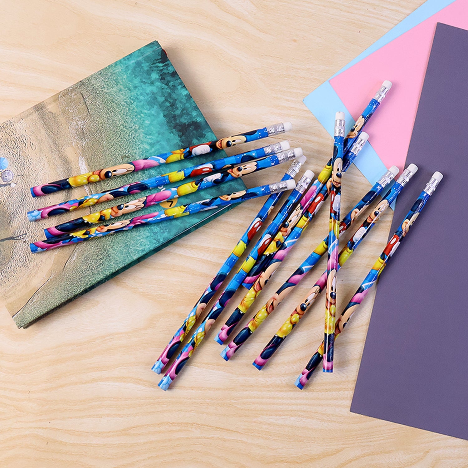 Pack of 12 wooden graphite pencils with eraser tips and vibrant cartoon prints