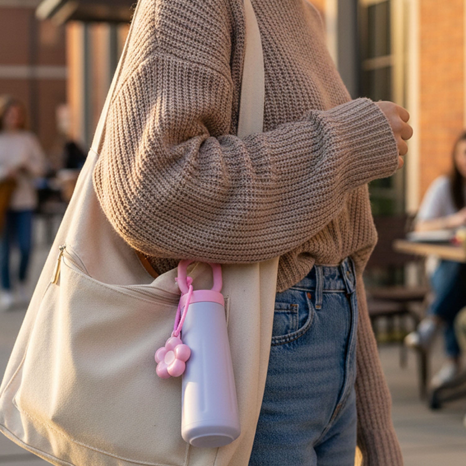 Portable 450ML water bottle with decorative charm and hanging loop
