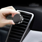 Rotating magnetic phone holder holding smartphone inside vehicle