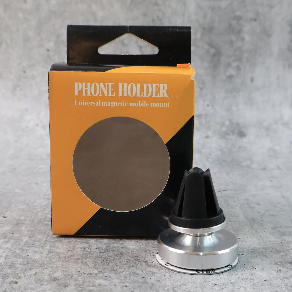 Rotating magnetic phone holder securing smartphone on car dashboard