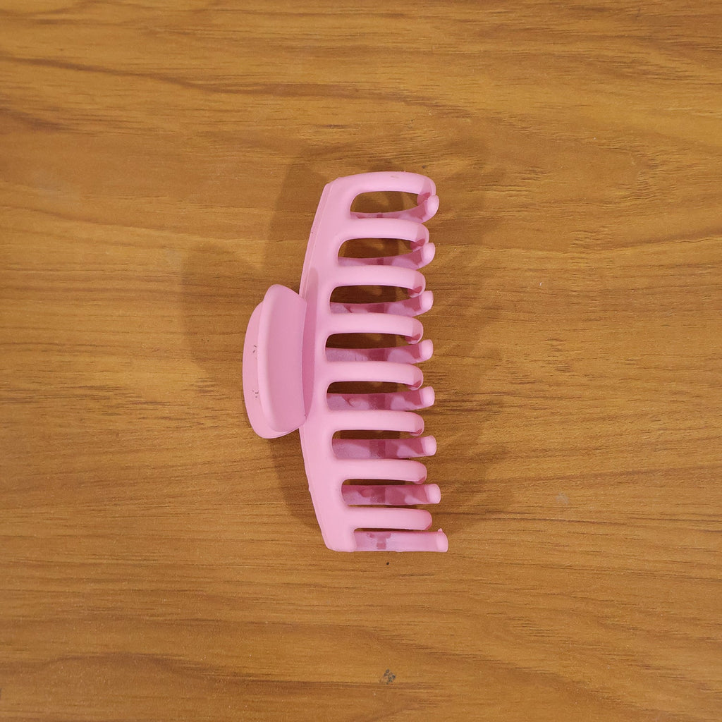 Model wearing elegant pink hair claw clip in styling