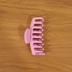 Model wearing elegant pink hair claw clip in styling