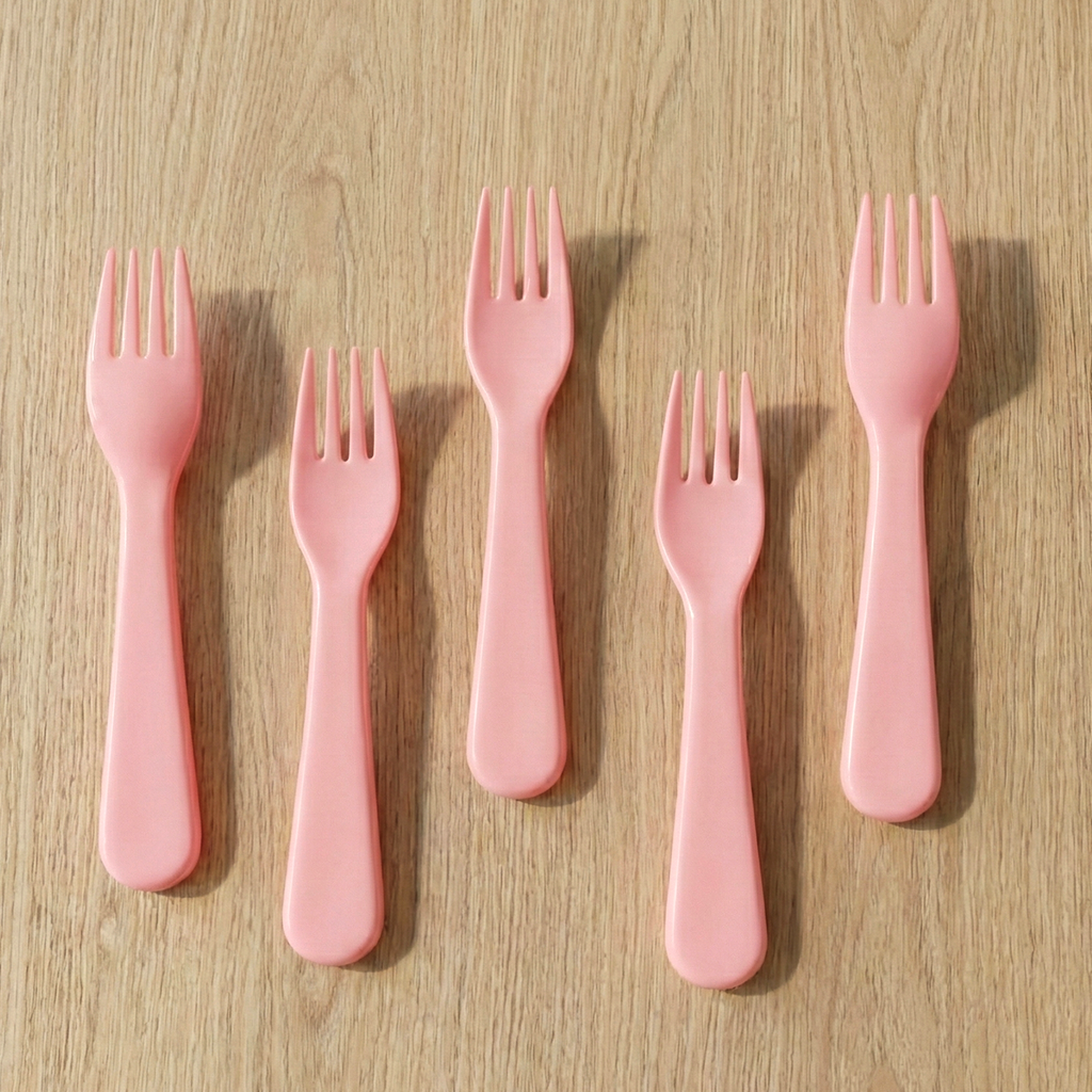 Pink plastic fork spoon used for a dessert.