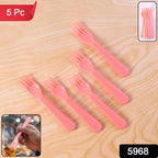 Close-up of a single pink plastic fork spoon.