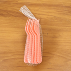 Pink plastic fork spoon being held, ready for use.